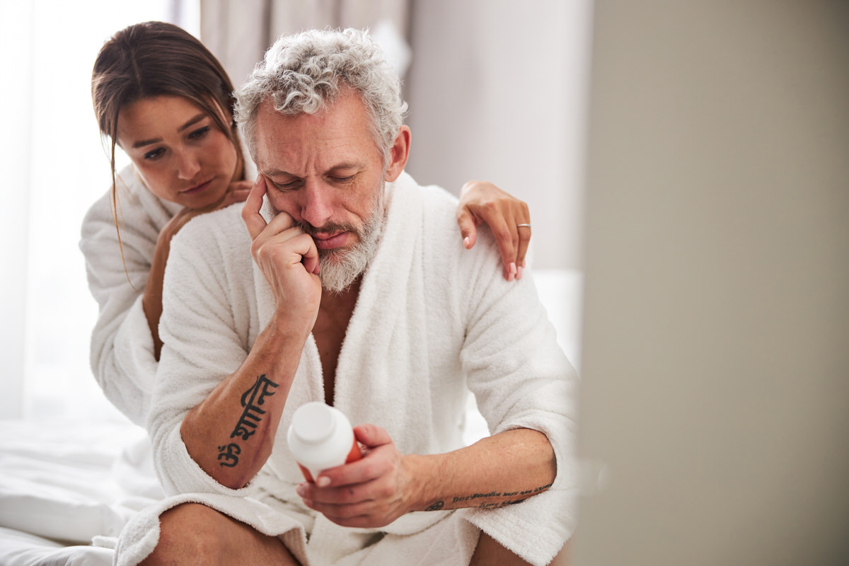 Upset couple looking at a medicine bottle