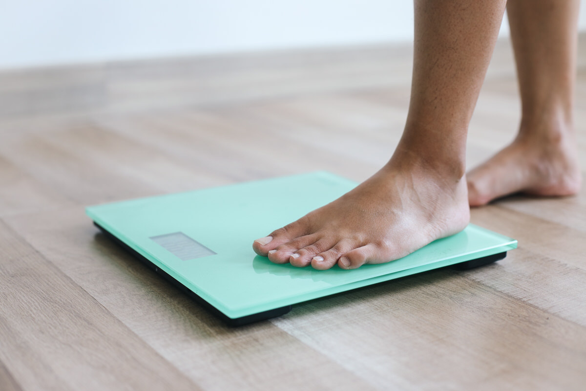 Person stepping on a weight scale